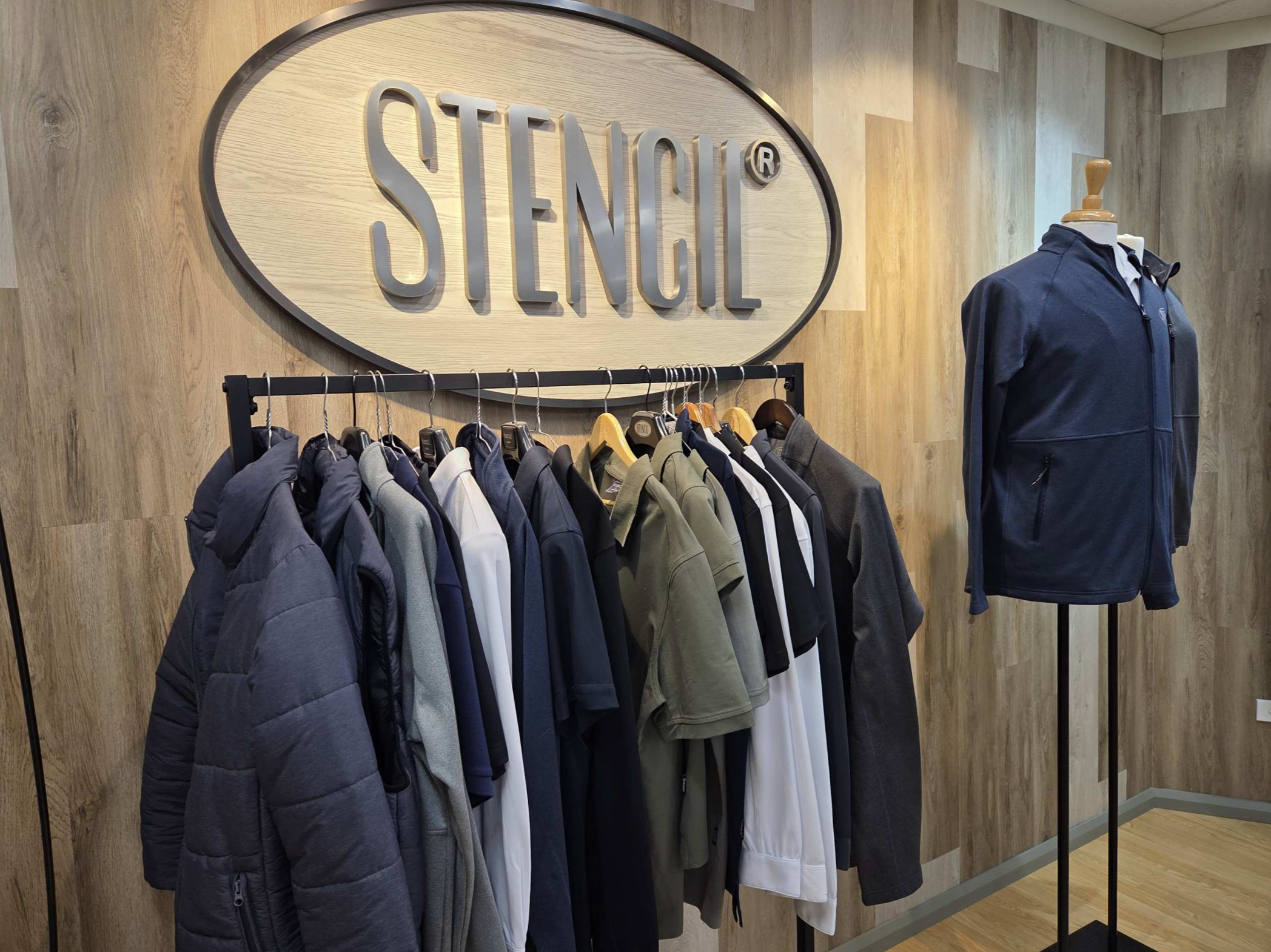 uniform samples with a stencil logo on the wall
