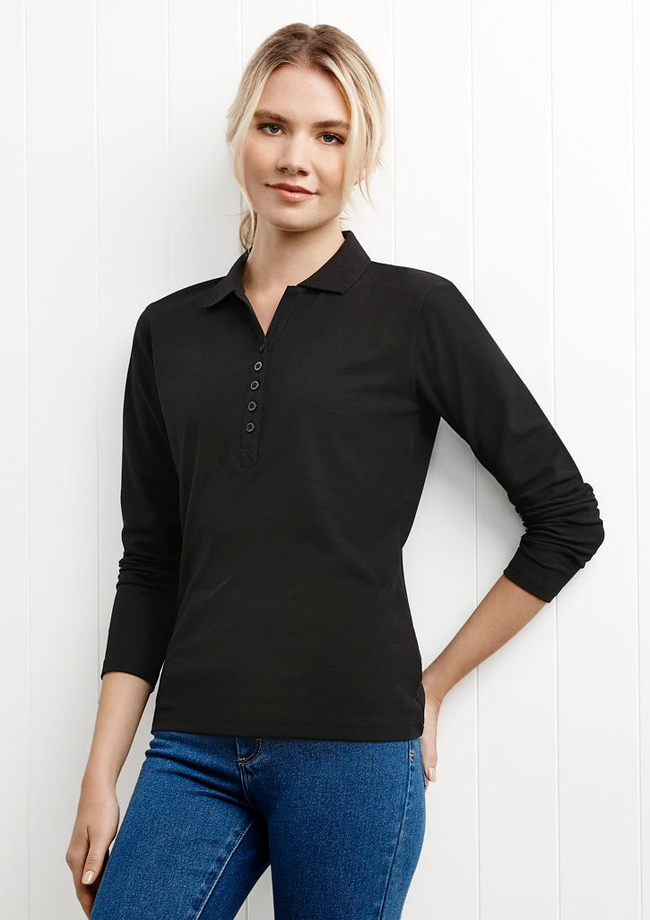 Image of a woman wearing a Millo Long Sleeve Women's Polo at a fall gathering.